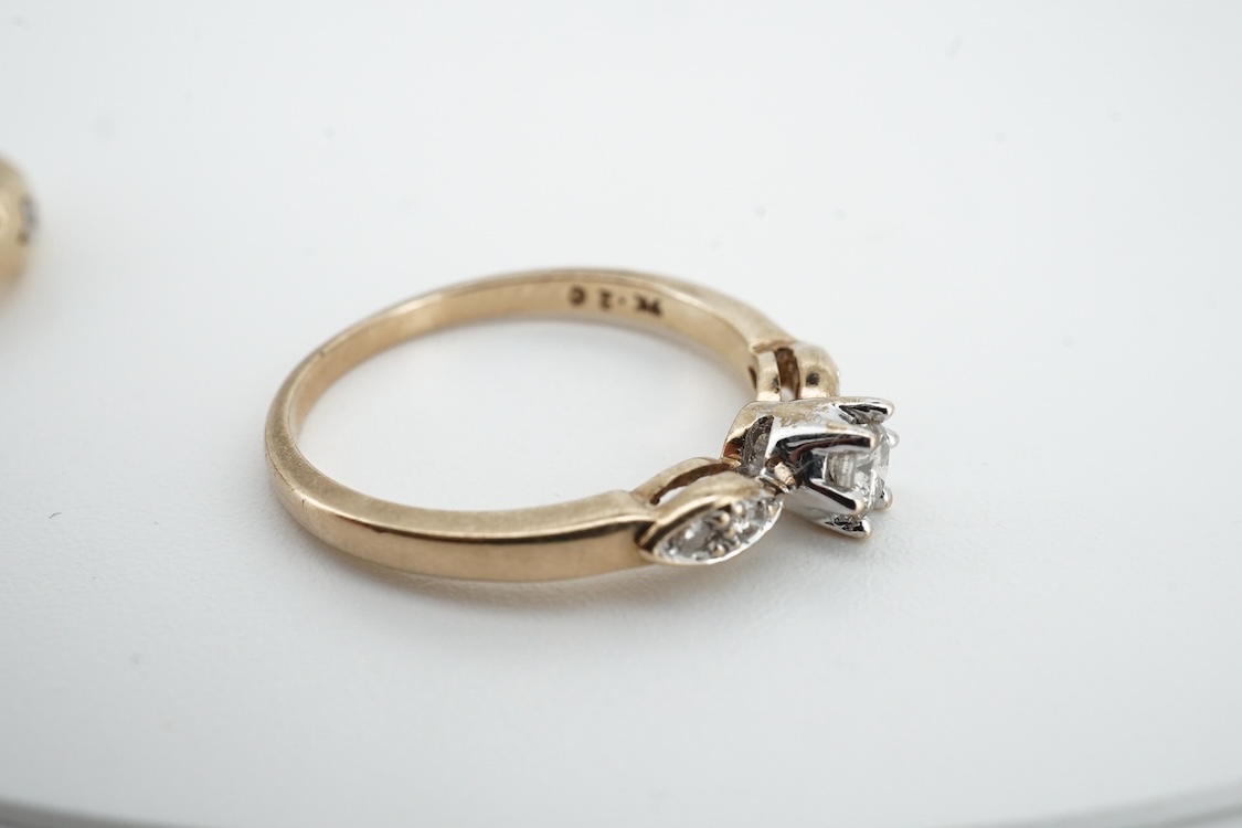 A modern 9ct gold and claw set single stone diamond ring, with four stone diamond chip set shoulders, size N, total carat weight approximately 0.20ct and a similar 9ct gold and six stone diamond set band, size K, gross w